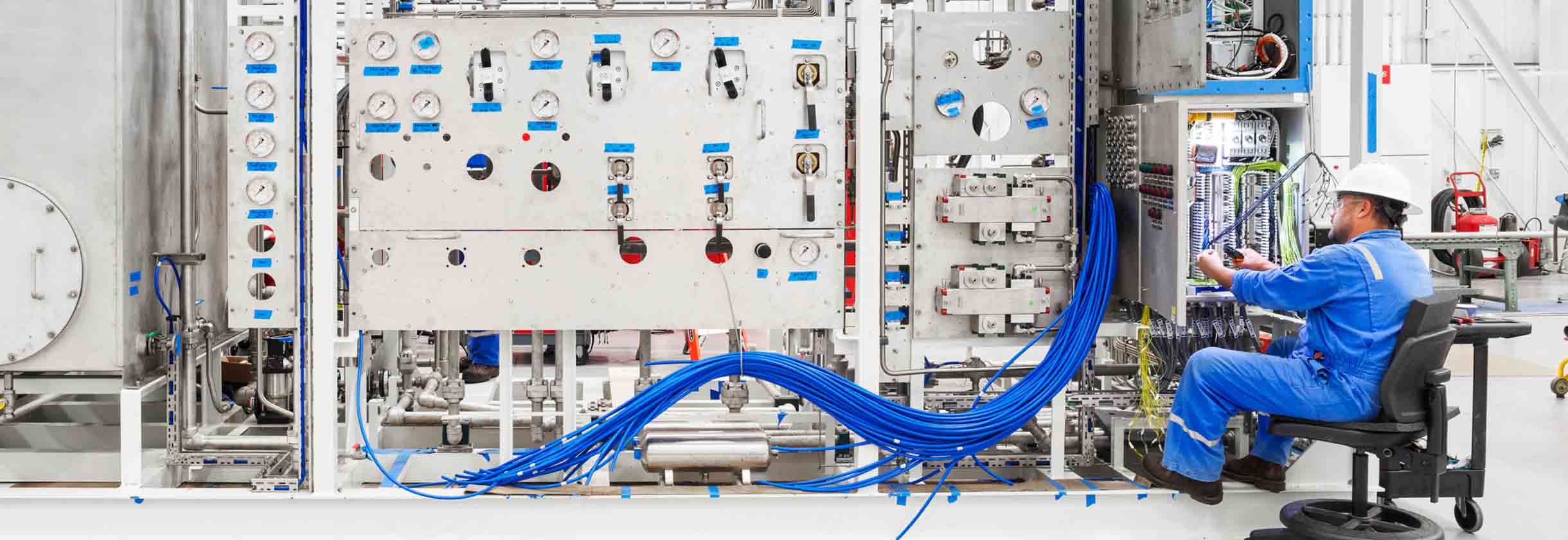 Male SLB operator testing the electrical component on equipment