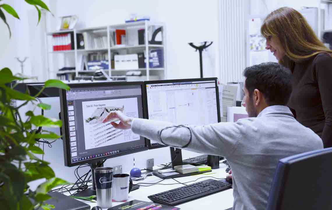 Man and woman reviewing seismic data at Milan, Italy facility