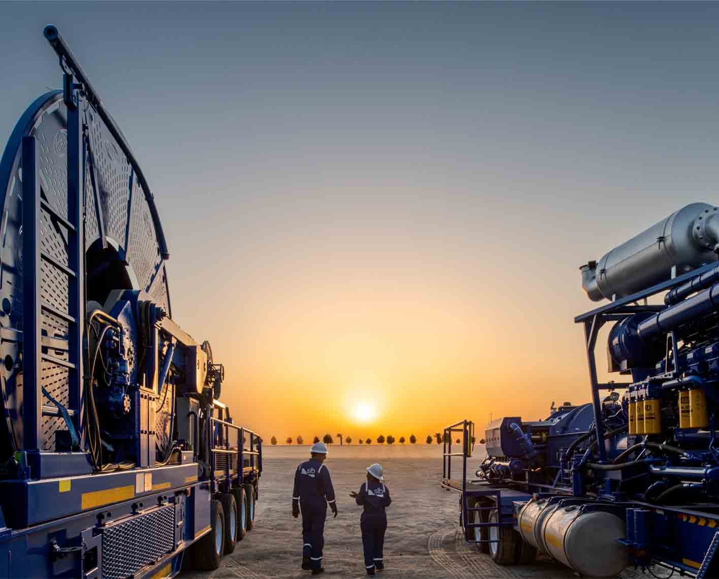 Sunset over reservoir testing equipment and people