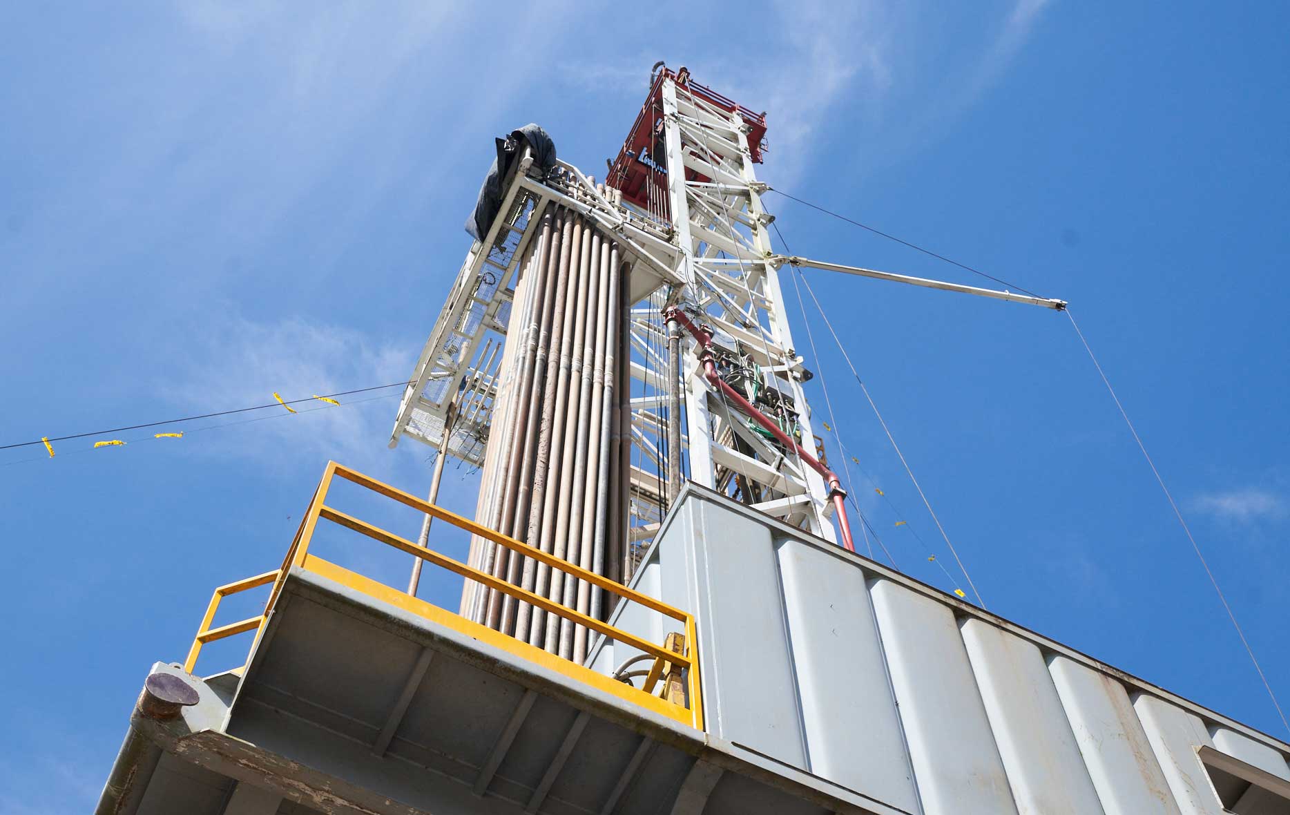 Perspective from the group looking up at a drilling land rig